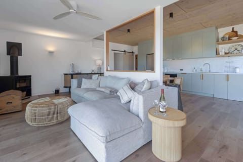 Living room has modular lounge with chaise to take in the stunning  views