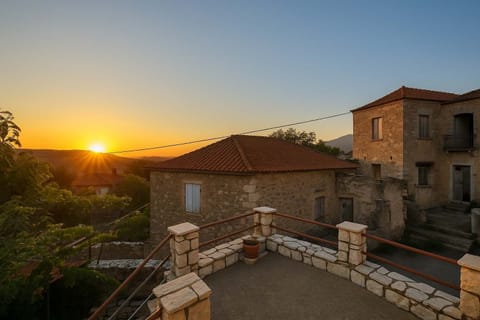 Sunset from the Terrace of the House – A breathtaking evening view over the stone rooftops and hills.