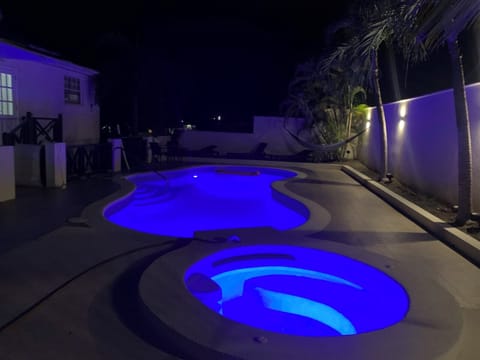 Large pool and spa Jacuzzi by night