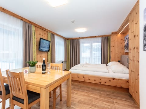 Bedroom in the holiday apartment Appartements Hollin in Saalbach by we rent apartments, featuring a cozy double bed.