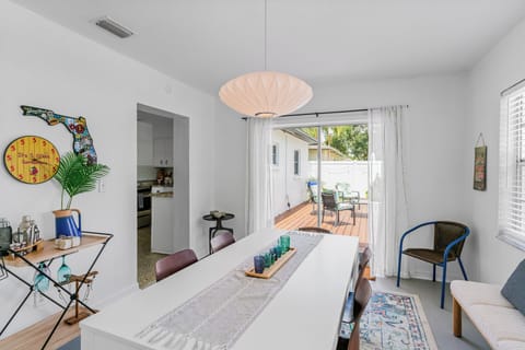 A spacious dining area with natural light and a view of the charming outdoor space.