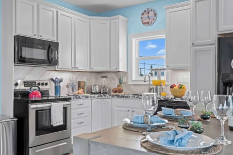 Bright, modern kitchen with chic decor and ocean views for culinary adventures!