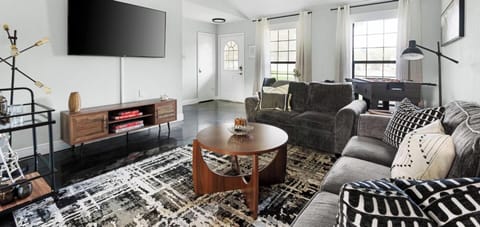 Relax in this bright, airy living room with plush sofas, a modern entertainment system, and cooling ceiling fans—perfect for unwinding after a day at Old Settlers Park or Kalahari Waterpark!