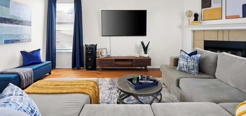 Inviting living room with a plush sectional, smart TV, and stylish décor. Conveniently located near Dell Diamond, Kalahari, and Round Rock Donuts—ideal for relaxing!