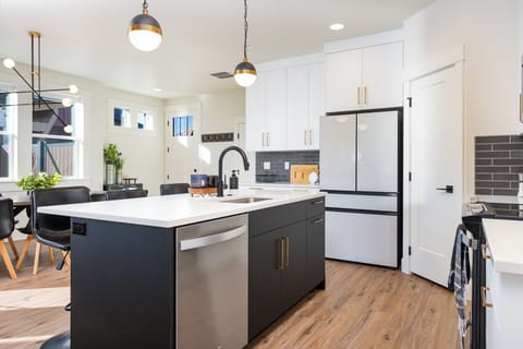 Enjoy a fresh, contemporary kitchen with a soothing gray-and-white color scheme and sleek, modern details