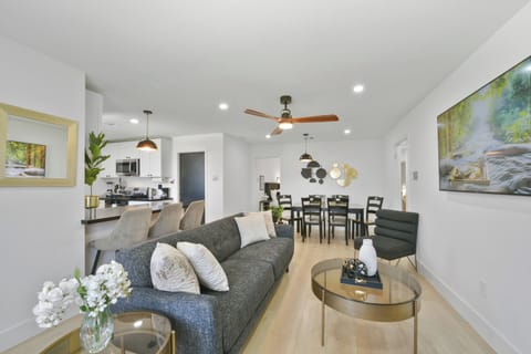 Unwind in the open-concept living room, featuring a sofa, smart TV. Ideal for gatherings, with board games and ample seating, creating a welcoming space for everyone to relax and connect.