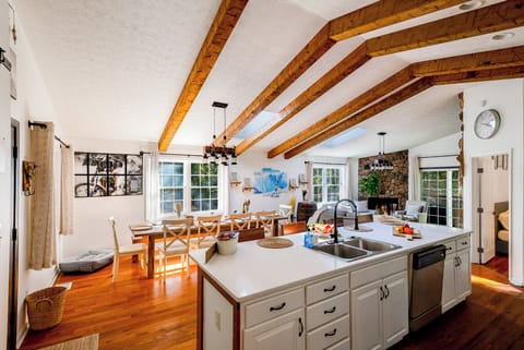 Spacious open kitchen with rustic charm, natural light, and a social vibe.