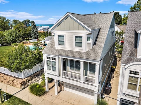 Aerial view of the front of the house with the pool and recreation area behind.