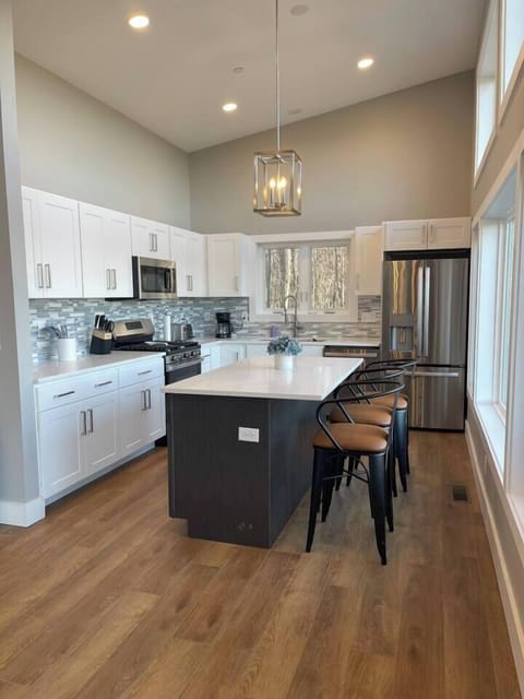 Spacious modern kitchen with island and stools