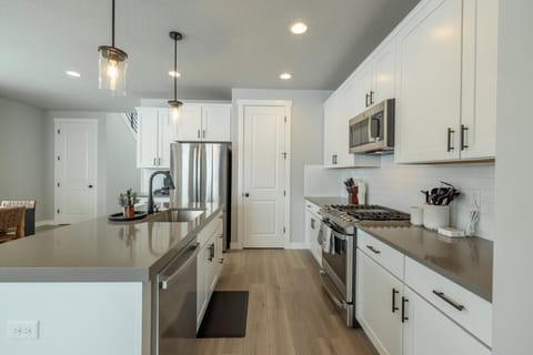 Spacious kitchen with island seating and open-concept layout.