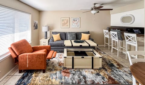Living Room Features Recliner and Coffee Table that Opens toward couch
