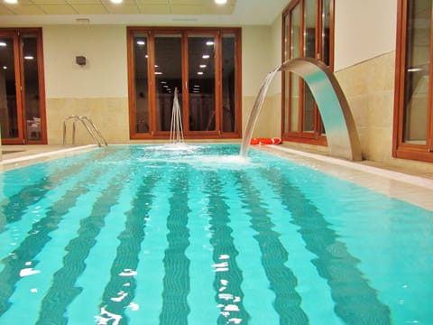Indoor pool, seasonal outdoor pool, open noon to 8:00 PM, pool umbrellas