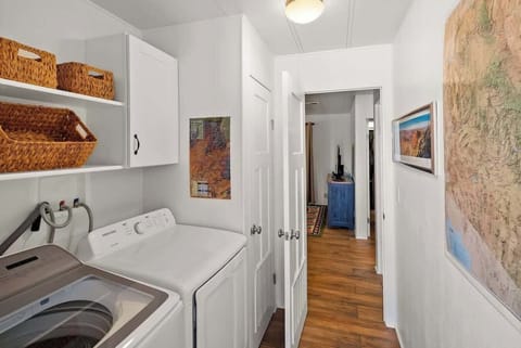 Convenient in-unit laundry area with washer, dryer, and storage.
