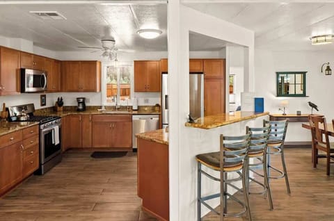 Fully equipped kitchen with modern appliances and a breakfast bar for easy meals.