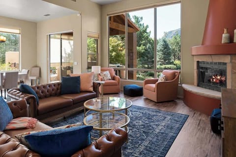 Cozy up by the fireplace in this inviting living area with stunning views.