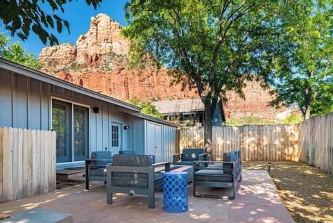 Fenced in backyard with amazing views and comfortable seating.