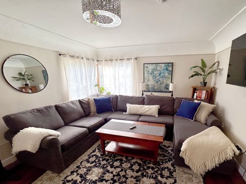 Living room space. The coffee table raises and opens to a large game/dining tabl