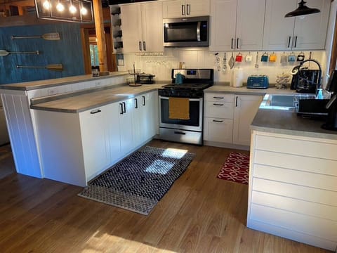 The fully-stocked kitchen has all brand-new appliances including a gas grill, microwave, fridge and dishwasher. Coffee pot, Kurig, waffle-maker and toaster included.
