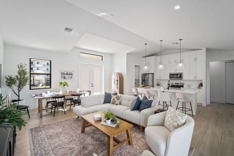 Spacious and bright living area with comfy seating and a coastal vibe