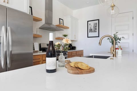 Modern kitchen with a spacious pantry and a large island with five barstools, ideal for cooking and casual dining