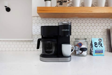Clean and Spacious Kitchen with Sleek Countertops and Additional Seating