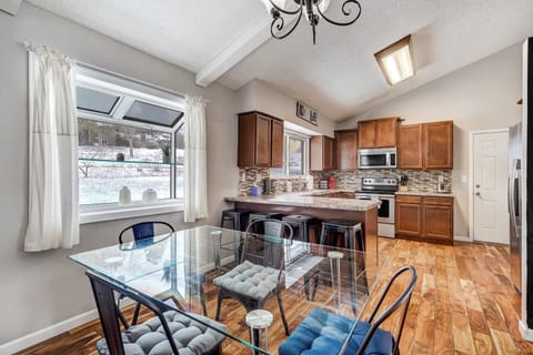 The bright and spacious kitchen is fully equipped with stainless steel appliances, ample counter space, and a breakfast bar. The adjacent dining area offers a stylish setting for enjoying meals with family and friends.