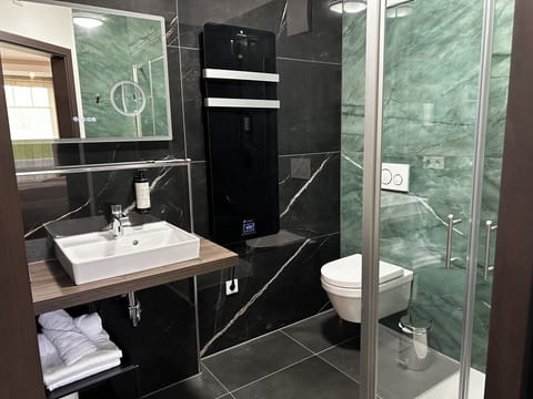 Shower, rainfall showerhead, hair dryer, towels