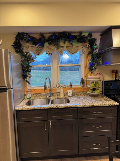 In the kitchen you find it fully stocked, and granite countertops.