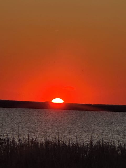 Enjoy front row seats to OBX sunsets over Kitty Hawk Bay from your back deck.