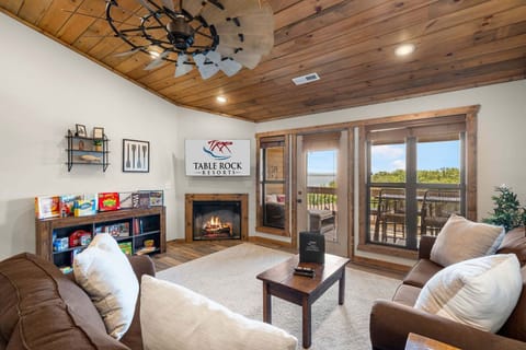 Living Room with Cable TV, Fireplace, Various Board Games, Sleeper Sofa, and Deck Access