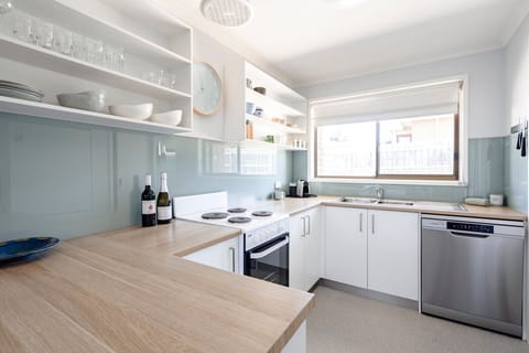 Cook with ease in the well-stocked kitchen with timber bench tops and quality appliances