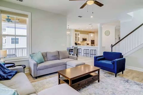 The living area is centered around a comfortable L-shaped gray sectional.