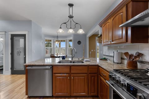 Modern kitchen featuring a gas stove, dishwasher, extra dining space, and everything you need for effortless cooking and entertaining during your stay.