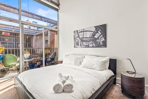 King size bed with large expansive windows and blackout shades