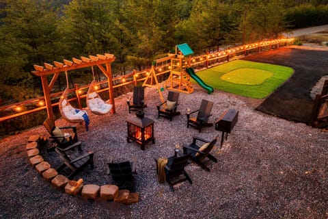 Amazing outdoor area with fire pit, swings, golf putting rink and play area!