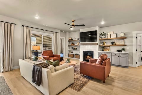 Step into a warm and inviting living space designed for relaxation and connection. This beautifully styled room features plush seating, a cozy fireplace, and a sleek smart TV—perfect for movie nights or unwinding after a day of adventure.