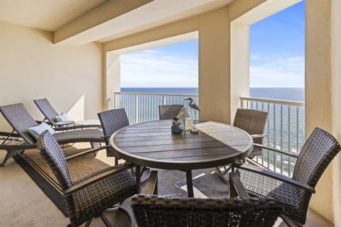 Your private oceanfront balcony awaits with comfortable wicker seating and endless sea views for morning coffee or sunset dining.