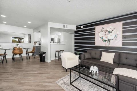 Bright, comfy living room with TV, sofa bed and dining area