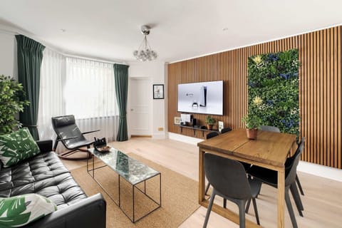 Living Room | An unrivalled living space featuring air-conditioned comfort, a stunning 75-inch Smart TV with a PS5, and elegant design for the ultimate relaxation experience.