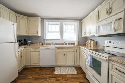 Kitchen stocked with pots and pans, utensils, cooking essentials.