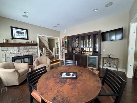 Wet bar area overlooking golf course with fireplace