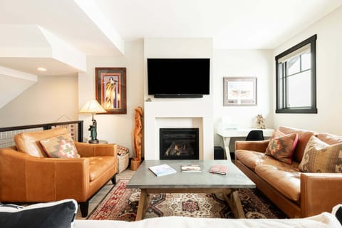 Living Room with Samsung smart tv, comfy furniture, gas fireplace, and small work area
