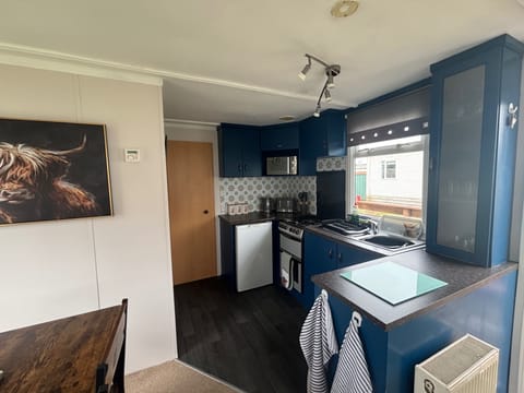 Kitchen with fridge, kettle, toaster, gas oven/hobs. Plates, bowls cutlery, glasses, mugs pots, pans and utensils provided. 