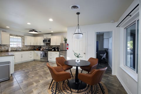 In the corner, you'll find a table with seating for 4—perfect for morning coffee, board games, or a quiet workspace.