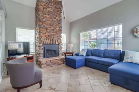 Original tiled living room with plenty of space for the family, pull out sofa bed, fireplace and central air conditioning.