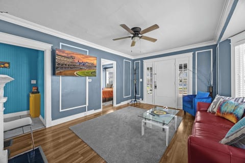 Living Room: Relax in this stylish living space with dark blue walls, large windows, and a charming fireplace.