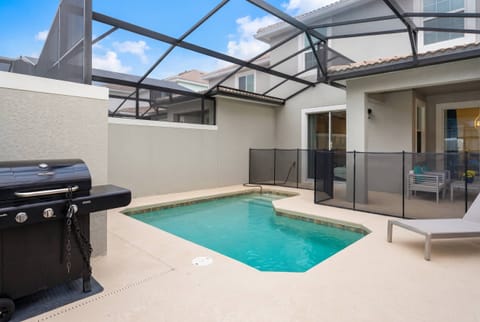 Step into your private oasis with a sparkling pool for refreshing dips and a sleek barbecue grill for evening cookouts, all complemented by modern lounge chairs perfect for relaxation in this stylish outdoor space.