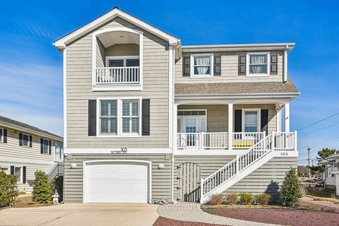 Modern beach house with multiple balconies and coastal charm in a quiet neighborhood setting.