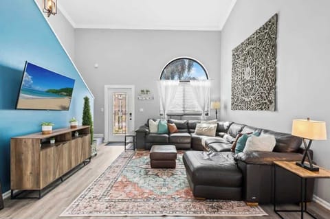 Spacious, beautifully decorated second living room with large, comfortable leather sectional. 
