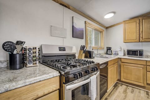 The kitchen is stocked with all the essentials, including a gas range, coffee maker, microwave, and a convenient spice rack for home-cooked meals.